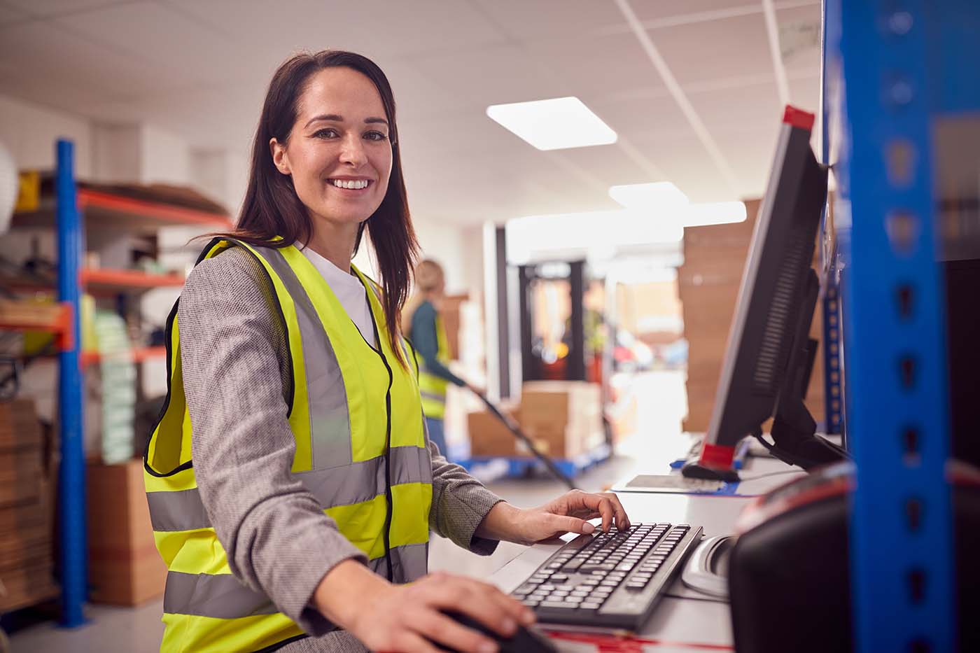 Portrait,Of,Female,Manager,In,Busy,Modern,Warehouse,Working,On